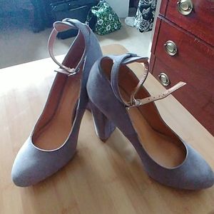 Grey suede pump with ankle strap.